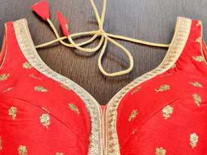 Buy gorgeous red sleeveless saree blouse online in USA with embroidered flowers. Elevate your ethnic saree style with a stunning collection of designer saree blouses, embroidered saree blouses, Banarasi sari blouse, silk sari blouse from Pure Elegance Indian clothing store in USA.-neck