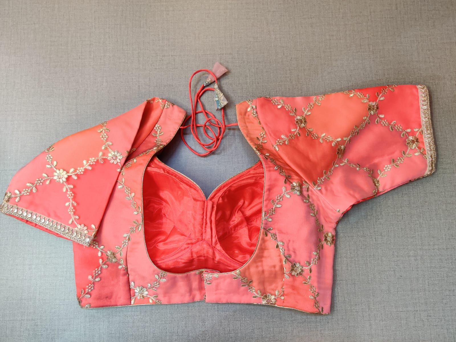 Shop beautiful coral embroidered sari blouse online in USA. Elevate your Indian ethnic saree looks with beautiful readymade saree blouse, embroidered saree blouses, Banarasi saree blouse, designer sari blouses, sleeveless saree blouses from Pure Elegance Indian fashion store in USA.-back