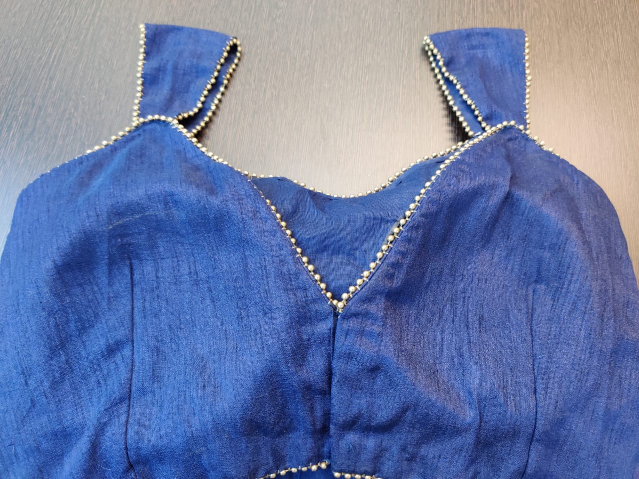 Buy stunning blue sleeveless saree blouse online in USA with golden beads lace. Elevate your ethnic sari style with a stunning collection of designer sari blouses, embroidered saree blouses, Banarasi sari blouse, silk saree blouse from Pure Elegance Indian clothing store in USA.-back