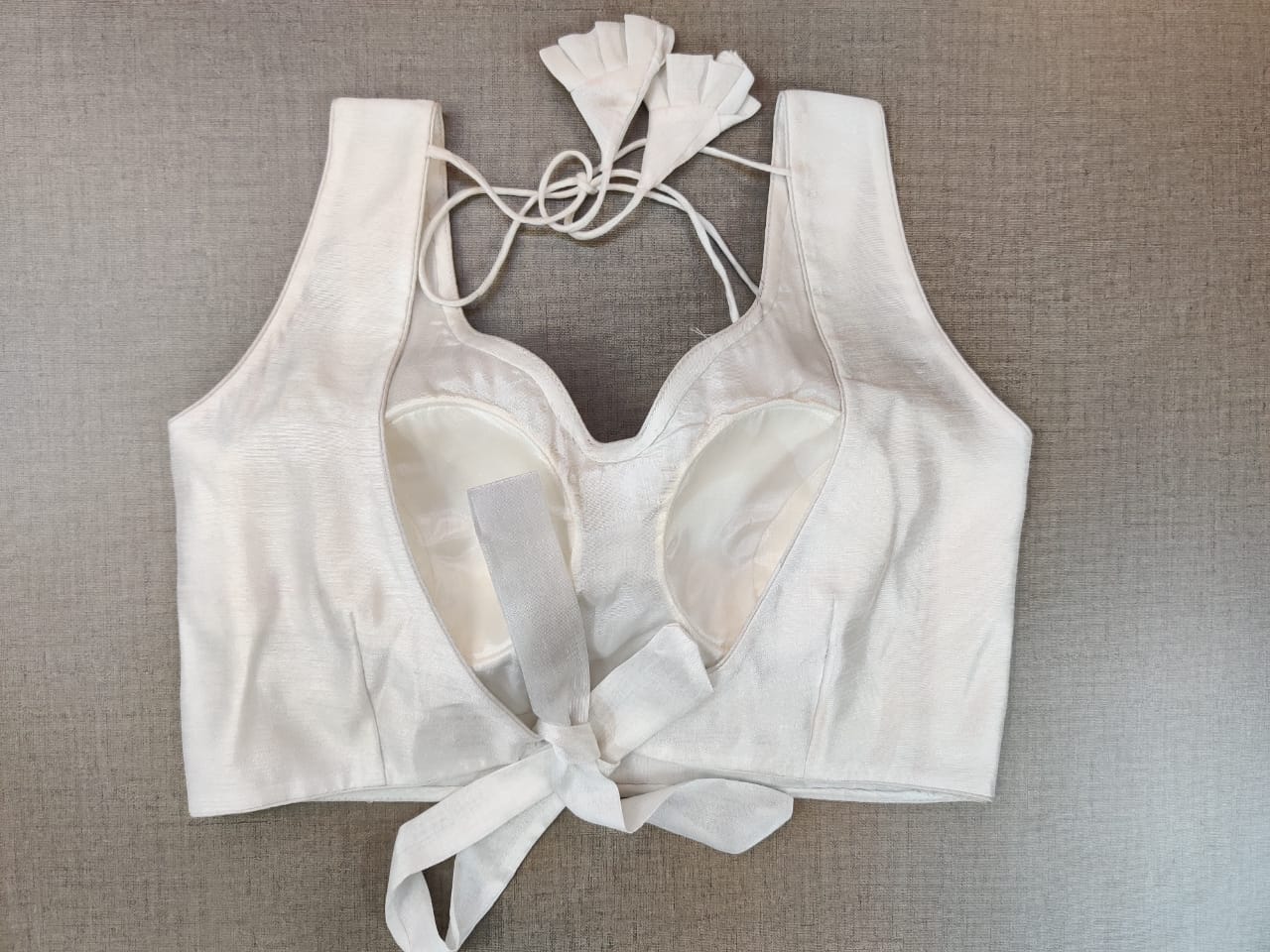 Shop gorgeous solid white sleeveless saree blouse online in USA. Elevate your Indian ethnic saree looks with beautiful readymade saree blouse, embroidered saree blouses, Banarasi saree blouse, designer sari blouses from Pure Elegance Indian fashion store in USA.-back