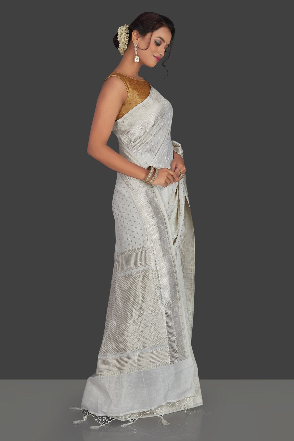 Shop white tassar georgette Banarsi saree online in USA with silver zari border. Radiate elegance with handloom sarees with blouse, tussar silk saris, Banarsi sarees from Pure Elegance Indian fashion boutique in USA. We bring a especially curated collection of ethnic saris for Indian women in USA under one roof!-side