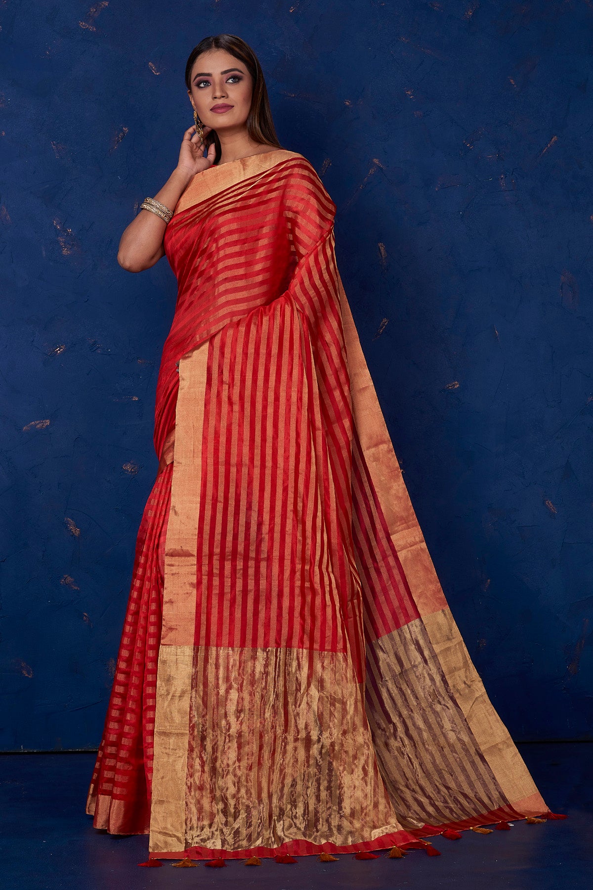 Buy stunning red striped tussar sari online in USA with golden zari border. Keep your ethnic wardrobe up to date with latest designer sarees, pure silk sarees, handwoven sarees, tussar silk sarees, embroidered sarees from Pure Elegance Indian saree store in USA.-full view