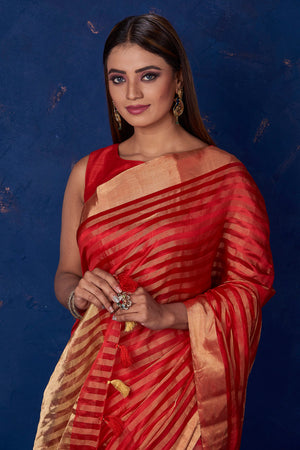 Buy stunning red striped tussar sari online in USA with golden zari border. Keep your ethnic wardrobe up to date with latest designer sarees, pure silk sarees, handwoven sarees, tussar silk sarees, embroidered sarees from Pure Elegance Indian saree store in USA.-closeup