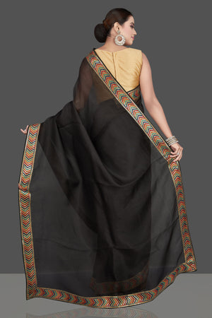 Shop beautiful black organza saree online in USA with golden border. Look attractive on weddings and parties in beautiful designer sarees, pure silk sarees, handwoven sarees, embroidered sarees, zari work sarees from Pure Elegance Indian saree store in USA.-back
