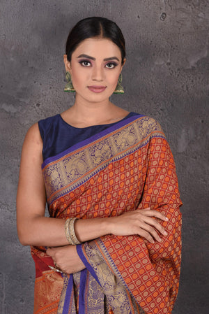 Buy beautiful dark red Kanchipuram cotton saree online in USA with blue zari border. Flaunt your ethnic style on special occasions with latest designer sarees, pure silk sarees, handwoven sarees, Kanchipuram silk sarees, embroidered sarees, georgette sarees from Pure Elegance Indian saree store in USA.-closeup