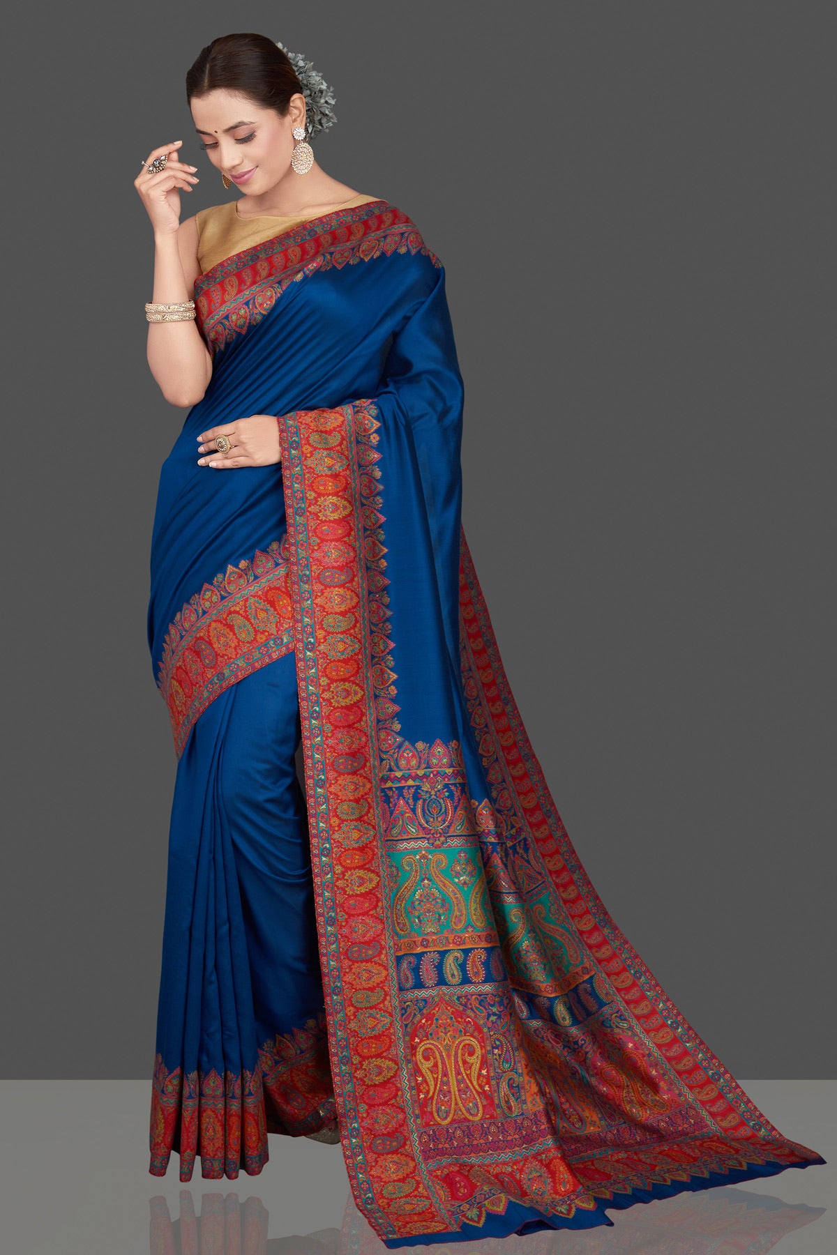Shop beautiful indigo blue silk saree online in USA with red Kani embroidery border. Get ready for festive occasions and weddings in tasteful designer sarees, Banarasi sarees, handwoven sarees from Pure Elegance Indian clothing store in USA.-full view