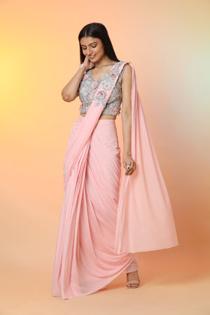 Buy stunning powder pink embroidered crepe ready-to-wear sari online in USA with blouse. Radiate glamor on special occasions in exquisite designer sarees, embroidered sarees, partywear saris, Bollywood sarees, fancy sarees from from Pure Elegance Indian saree store in USA.-front