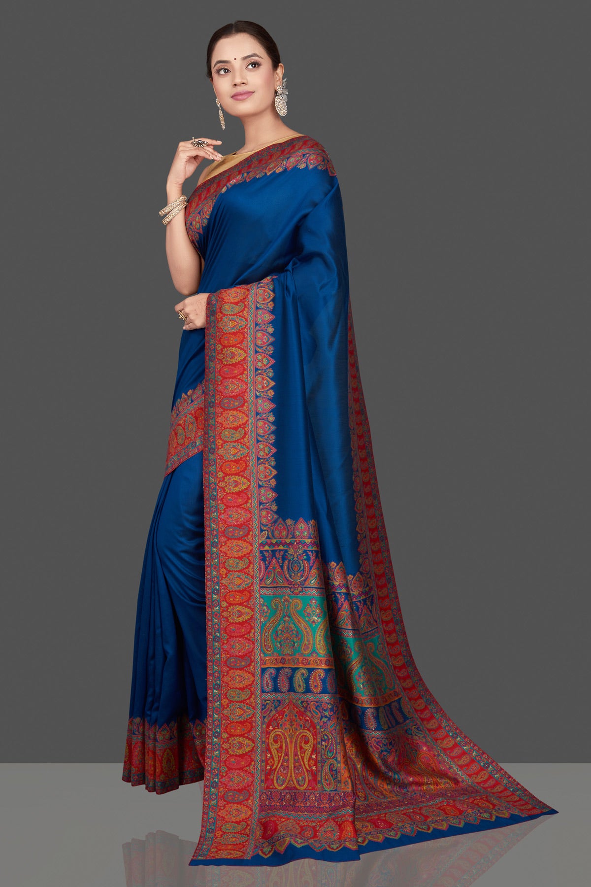 Shop beautiful indigo blue silk saree online in USA with red Kani embroidery border. Get ready for festive occasions and weddings in tasteful designer sarees, Banarasi sarees, handwoven sarees from Pure Elegance Indian clothing store in USA.-pallu
