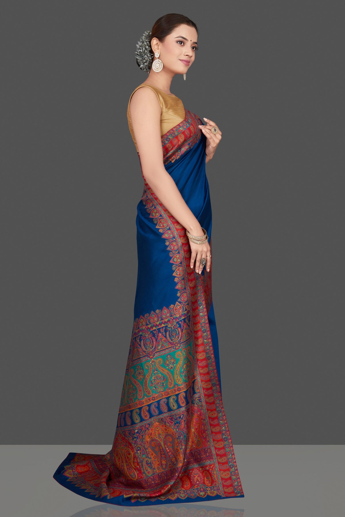 Shop beautiful indigo blue silk saree online in USA with red Kani embroidery border. Get ready for festive occasions and weddings in tasteful designer sarees, Banarasi sarees, handwoven sarees from Pure Elegance Indian clothing store in USA.-side