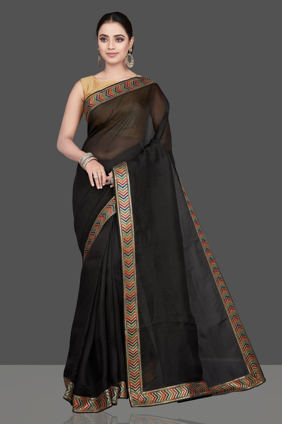 Shop beautiful black organza saree online in USA with golden border. Look attractive on weddings and parties in beautiful designer sarees, pure silk sarees, handwoven sarees, embroidered sarees, zari work sarees from Pure Elegance Indian saree store in USA.-full view