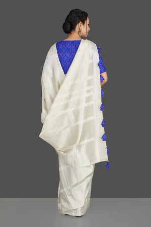 Buy lovely off-white tassar silk sari online in USA with blue patola ikkat saree blouse. Make your ethnic wardrobe rich with timeless handwoven sarees, tissue sarees, silk sarees, tussar saris from Pure Elegance Indian clothing store in USA. Find all the designer sarees for special occasions under one roof!-back