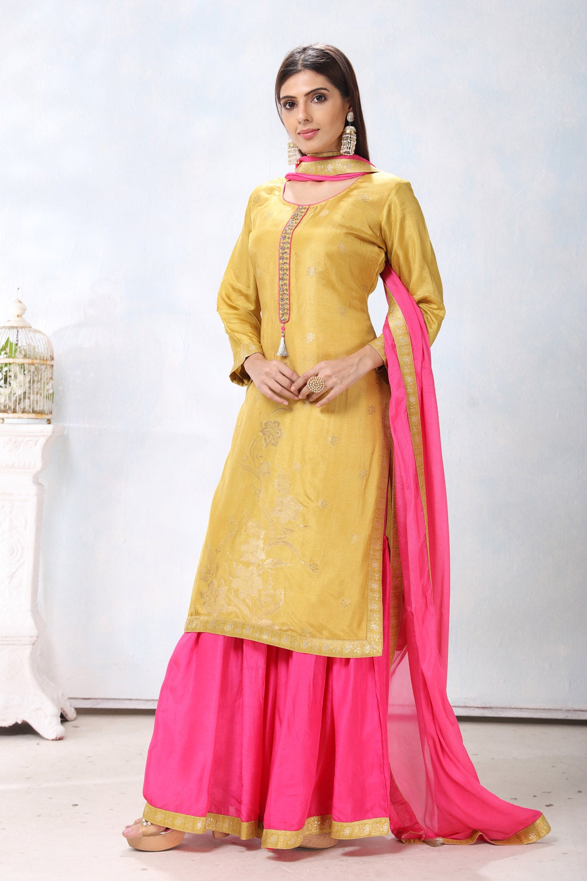 Buy gorgeous yellow embroidered sharara suit online in USA with pink dupatta. Flaunt Indian style at parties and weddings in beautiful designer dresses, salwar suits, Anarkali suits, gowns, palazzo suits from Pure Elegance Indian fashion store in USA.-side