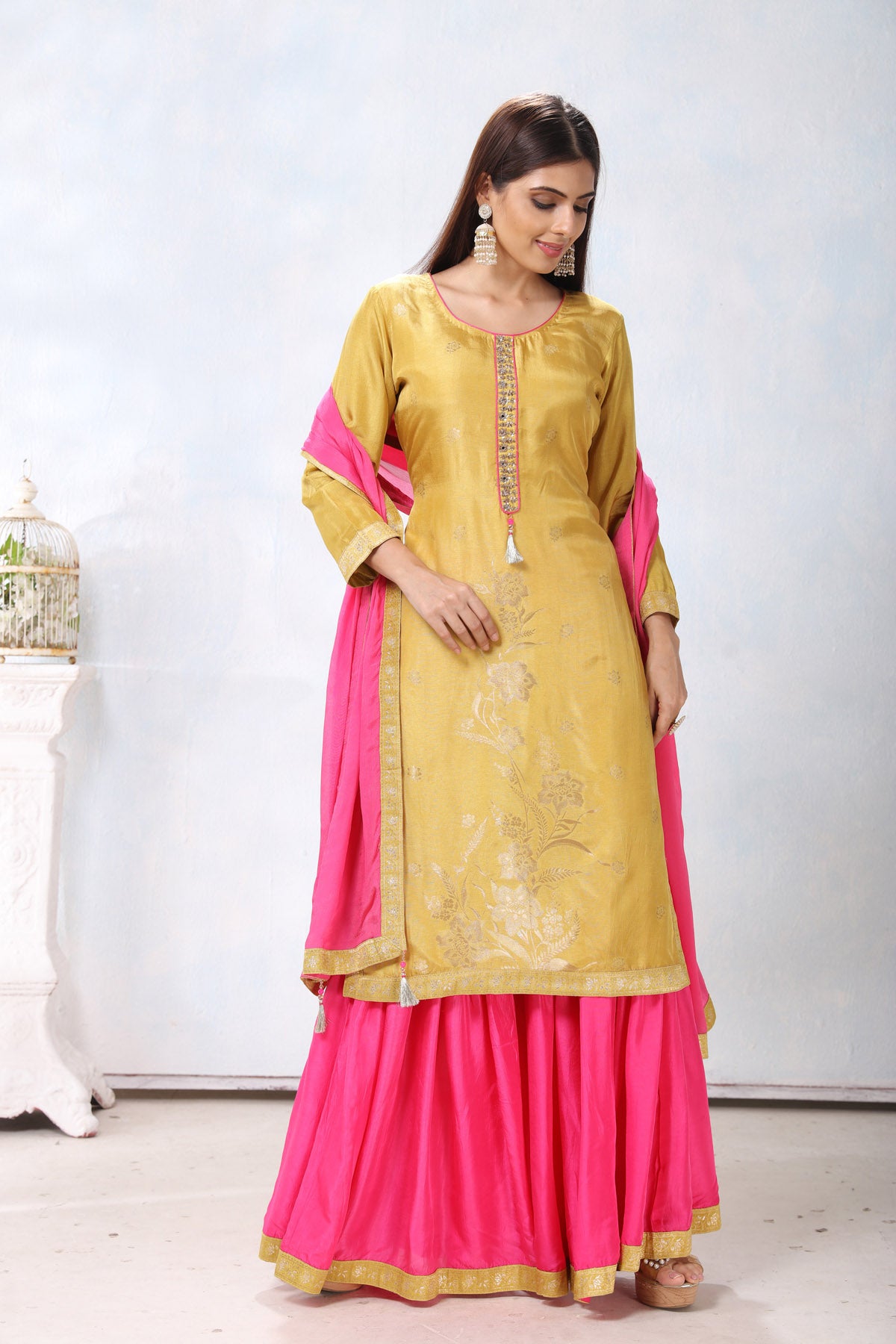 Buy gorgeous yellow embroidered sharara suit online in USA with pink dupatta. Flaunt Indian style at parties and weddings in beautiful designer dresses, salwar suits, Anarkali suits, gowns, palazzo suits from Pure Elegance Indian fashion store in USA.-front