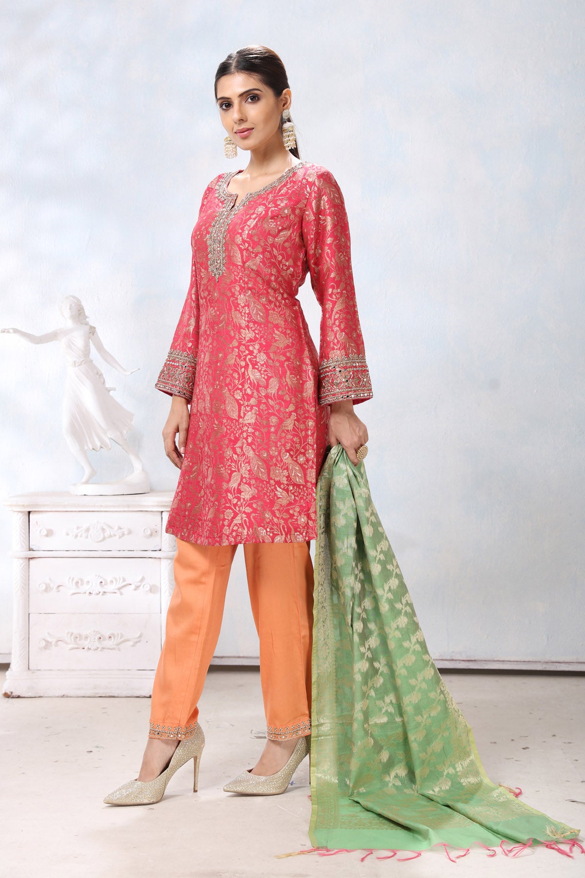 Buy beautiful pink embroidered suit online in USA with orange pants and green dupatta. Flaunt Indian style at parties and weddings in beautiful designer dresses, salwar suits, Anarkali suits, gowns, palazzo suits from Pure Elegance Indian fashion store in USA.-side