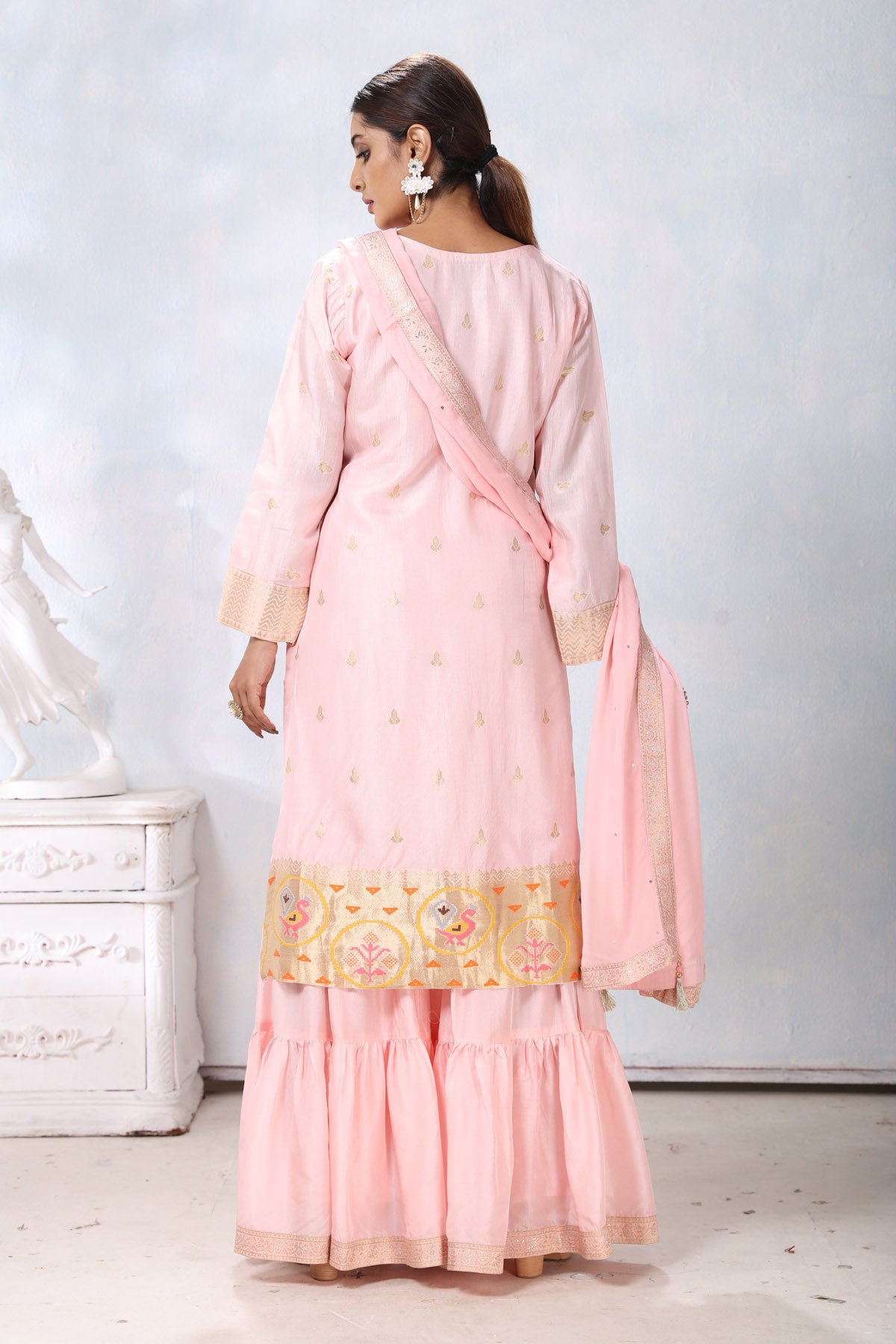 Shop stunning powder pink embroidered sharara suit online in USA with dupatta. Flaunt Indian style at parties and weddings in beautiful designer dresses, salwar suits, Anarkali suits, gowns, palazzo suits from Pure Elegance Indian fashion store in USA.-back