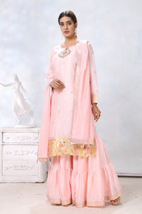 Shop stunning powder pink embroidered sharara suit online in USA with dupatta. Flaunt Indian style at parties and weddings in beautiful designer dresses, salwar suits, Anarkali suits, gowns, palazzo suits from Pure Elegance Indian fashion store in USA.-full view