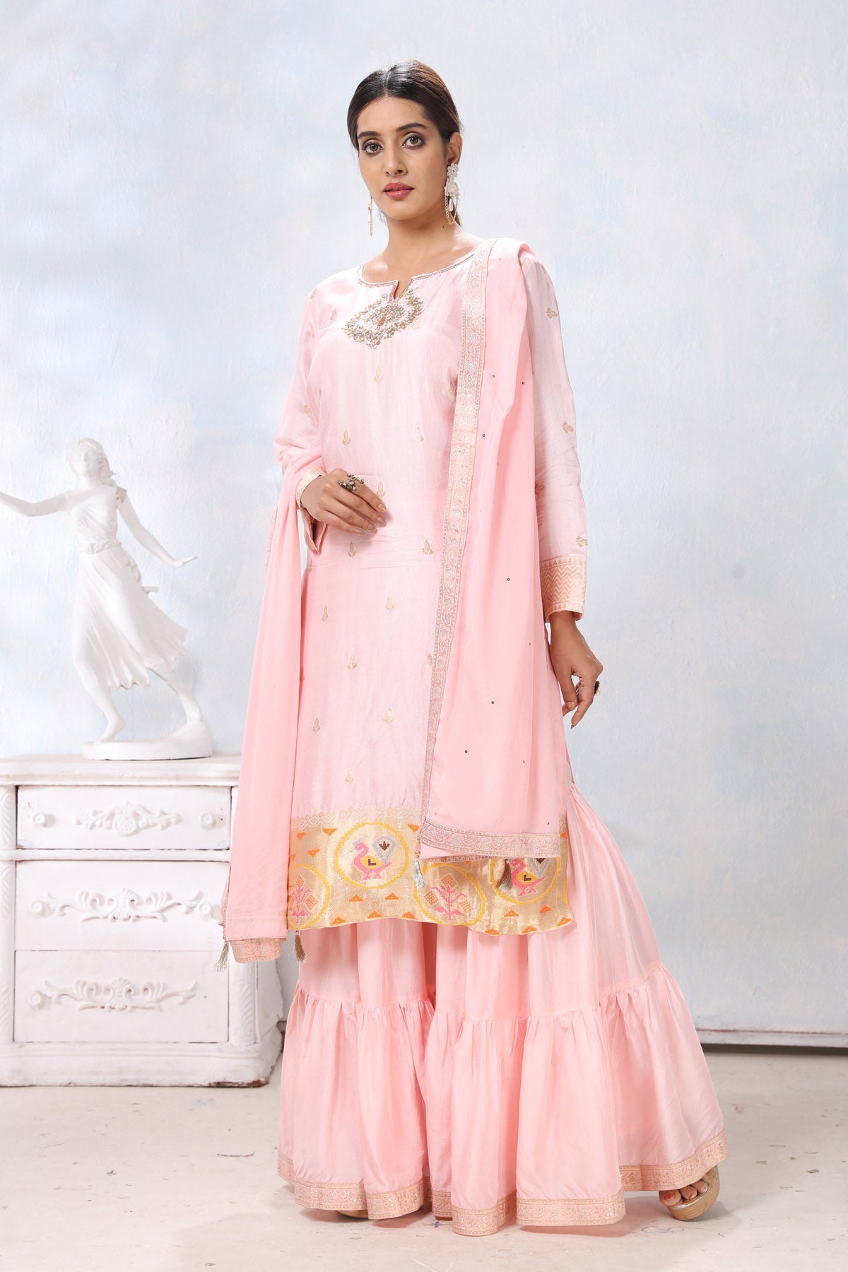 Shop powder pink embroidered sharara suit online in USA with dupatta. Flaunt Indian style at parties and weddings in beautiful designer dresses, salwar suits, Anarkali suits, gowns, palazzo suits from Pure Elegance Indian fashion store in USA.-full view
