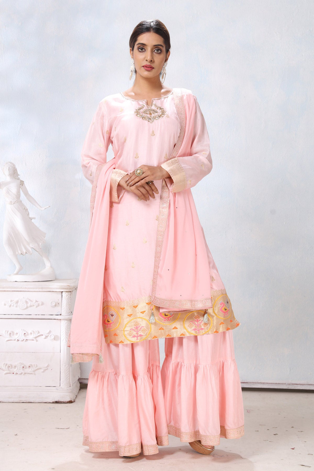 Shop stunning powder pink embroidered sharara suit online in USA with dupatta. Flaunt Indian style at parties and weddings in beautiful designer dresses, salwar suits, Anarkali suits, gowns, palazzo suits from Pure Elegance Indian fashion store in USA.-front