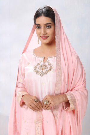 Shop stunning powder pink embroidered sharara suit online in USA with dupatta. Flaunt Indian style at parties and weddings in beautiful designer dresses, salwar suits, Anarkali suits, gowns, palazzo suits from Pure Elegance Indian fashion store in USA.-closeup