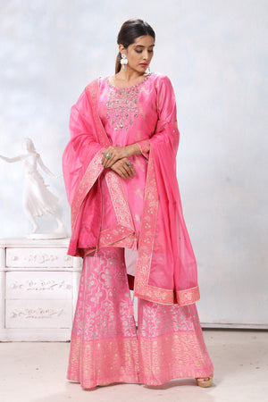 Shop stunning pink embroidered sharara suit online in USA with dupatta. Flaunt Indian style at parties and weddings in beautiful designer dresses, salwar suits, Anarkali suits, gowns, palazzo suits from Pure Elegance Indian fashion store in USA.-front