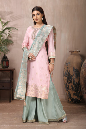 Buy gorgeous powder pink embroidered sharara suit online in USA with grey dupatta. Flaunt Indian style at parties and weddings in beautiful designer dresses, salwar suits, Anarkali suits, gowns, palazzo suits from Pure Elegance Indian fashion store in USA.-side