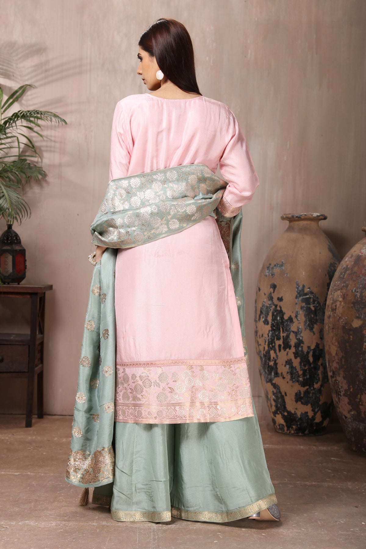 Buy gorgeous powder pink embroidered sharara suit online in USA with grey dupatta. Flaunt Indian style at parties and weddings in beautiful designer dresses, salwar suits, Anarkali suits, gowns, palazzo suits from Pure Elegance Indian fashion store in USA.-back