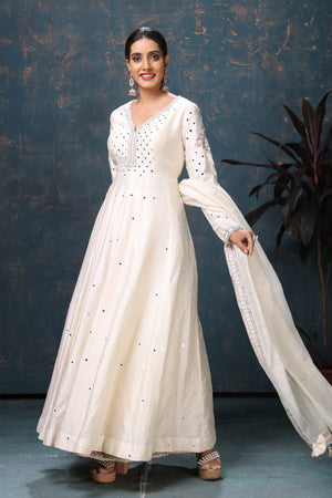 Shop stunning off-white embroidered Anarkali suit online in USA with dupatta. Flaunt Indian style at parties and weddings in beautiful designer dresses, salwar suits, Anarkali suits, gowns, palazzo suits from Pure Elegance Indian fashion store in USA.-left