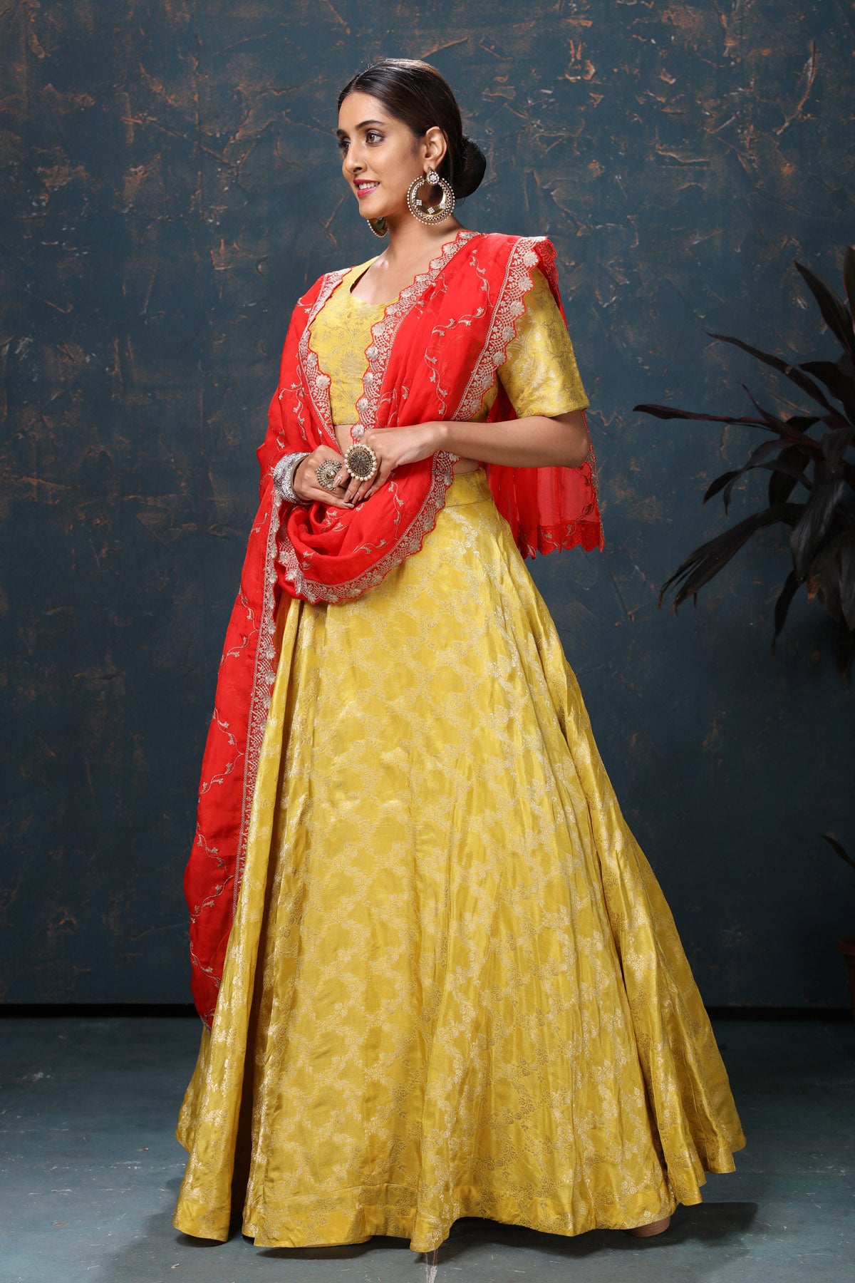 Shop beautiful yellow crepe Banarasi lehenga online in USA with red dupatta. Flaunt Indian style at parties and weddings in beautiful designer dresses, salwar suits, Anarkali suits, gowns, palazzo suits from Pure Elegance Indian fashion store in USA.-side