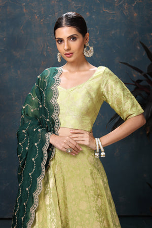 Buy beautiful pista green crepe Banarasi lehenga online in USA with dark green dupatta. Flaunt Indian style at parties and weddings in beautiful designer dresses, salwar suits, Anarkali suits, gowns, palazzo suits from Pure Elegance Indian fashion store in USA.-closeup