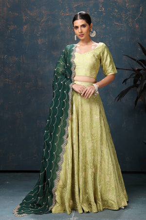 Buy beautiful pista green crepe Banarasi lehenga online in USA with dark green dupatta. Flaunt Indian style at parties and weddings in beautiful designer dresses, salwar suits, Anarkali suits, gowns, palazzo suits from Pure Elegance Indian fashion store in USA.-front