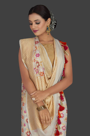 Buy beautiful cream georgette Banarasi sari online in USA with zari minakari floral work. Radiate elegance with georgette sarees, Banarasi sarees, handwoven sarees from Pure Elegance Indian fashion boutique in USA. We bring a especially curated collection of ethnic sarees for Indian women in USA under one roof!-closeup